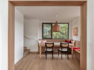 a kitchen and dining room with a table and chairs at Wild Pond Villa in Mansonville