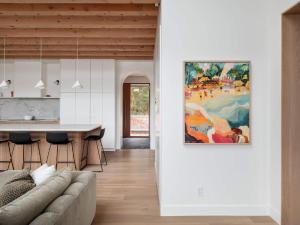 a kitchen and living room with a painting on the wall at Wild Pond Villa in Mansonville
