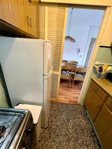 a kitchen with a refrigerator and a dining room at Edificio Carbe Punta del Este - Frente al Mar -parada 2 de la Mansa in Punta del Este +17 photos