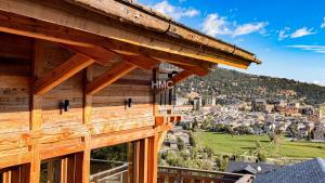 a view from the balcony of a log house at Agane skis aux pieds jacuzzi et vue montagne in Les Angles +15 photos