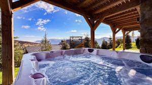 a hot tub in a gazebo with a view at Agane skis aux pieds jacuzzi et vue montagne in Les Angles