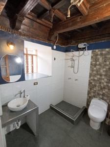 a bathroom with a toilet and a sink and a shower at Rumi's Inn in Cusco +21 photos