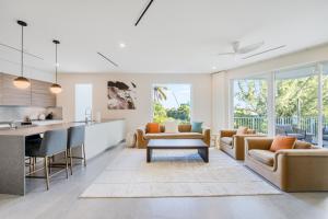 a kitchen and living room with couches and a table at Point West Premier Rentals in West Bay