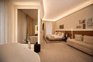 a large living room with a couch and a living room with a couch at Mamalu - Corso Umberto 35 - Studios and Suites in Naples