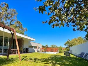 a swing in the yard of a house at Villa Branco - Private Pool & Garden in Barcelos