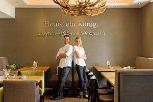 a man and a woman standing in a restaurant at Landgasthof Pappelkrug in Halle Westfalen