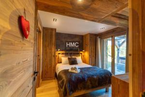 a bedroom with a bed with a teddy bear on it at Bliss luxe pyrénéen jacuzzi et vue montagne in Bolquere Pyrenees 2000