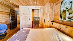 a bedroom with a bed in a wooden room at Ski Bob accès direct pistes jacuzzi privé in Bolquere Pyrenees 2000