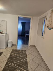 a living room with a toilet and a hallway at Apartment Kapetanovic in Bosanski Šamac +24 photos