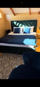 a bedroom with a bed with blue sheets and pillows at Гойра in Verkhniy Yasenov