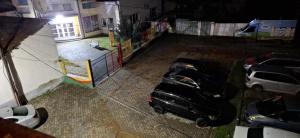 an overhead view of two cars parked in a parking lot at Illy Apartament in Gjakove