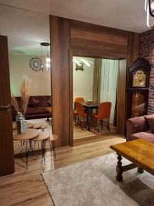 a living room with a couch and a table at Illy Apartament in Gjakove