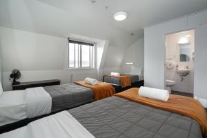 a hotel room with two beds and a bathroom at The Brownston Hostel in Wanaka +64 photos
