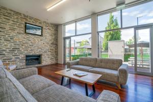 a living room with two couches and a fireplace at The Brownston Hostel in Wanaka