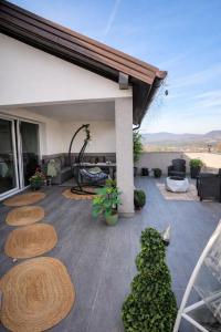 a patio with circular logs on the floor of a house at Villa Kaplan Sarajevo in Gladno Polje