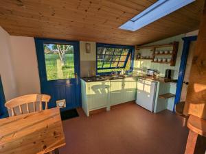 a small kitchen with a stove and a sink at Jay's Cabin in Skibbereen