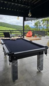 a pool table sitting on top of a patio at Casa com piscina aquecida, estilosa e privativa in Nazaré Paulista