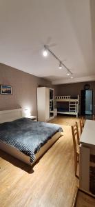 a bedroom with a bed and a kitchen and a table at Hotel Bobline 304 in Bakuriani