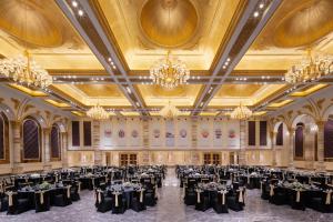a banquet hall with black tables and chandeliers at InterContinental Lhasa Paradise by IHG in Lhasa
