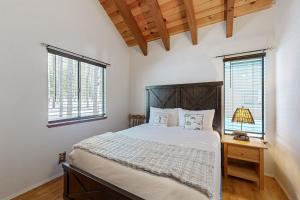 a bedroom with a large bed and two windows at < 2 Mi to Tahoe Donner Ski Resort: Serene Retreat in Armstrong
