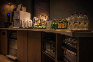 a bar with bottles of alcohol on a counter at BROWN DOT Hotel Dadaepo Beach in Busan