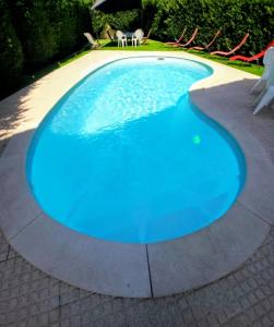 a large blue swimming pool on a patio at Vivenda Do Relaxo '' Relax Villa " in Freiria