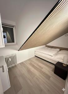 a white room with a bed and a window at Fewo Andresen Hahnenklee in Hahnenklee-Bockswiese