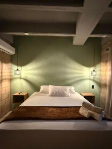 a bedroom with a large bed with two night stands at Aira Hotel in Coveñas