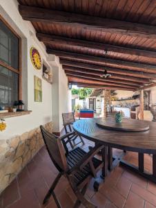 a dining room with a table and chairs on a patio at Azure Bay Chic Villa in Fontane Bianche