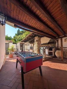 a ping pong table in the middle of a patio at Azure Bay Chic Villa in Fontane Bianche