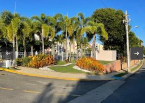 a street with a fence and palm trees at Luxury Apartment- 3 Bedrooms in Ceiba