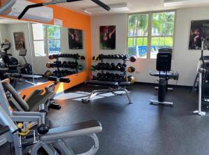 a gym with lots of exercise equipment in a room at Luxury Apartment- 3 Bedrooms in Ceiba