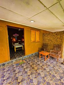 a living room with two chairs and a table at Elephant paradise Safari lodge in Udawalawe +21 photos
