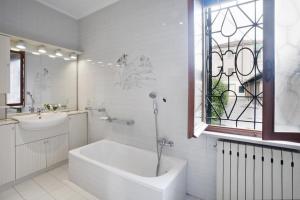 a bathroom with a tub and a sink and a window at Locappart Redentore in Venice