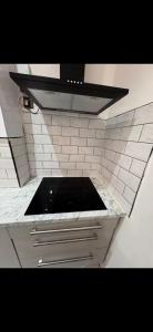a kitchen with a stove and a counter top at Mayford Shared House in Manchester