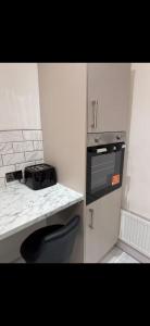 a small kitchen with a counter and a stove at Mayford Shared House in Manchester