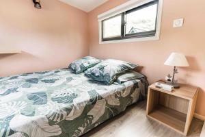 a small bedroom with a bed and a window at Matira Tiny House 2 in Bora Bora