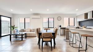 a kitchen and living room with a table and chairs at Lyra 2026 Home by GoodLive in Beveridge