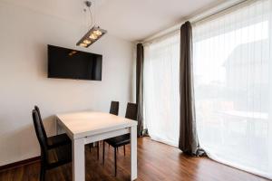 a dining room with a table and chairs and a window at Ferienwohnung-Mour in Dahme