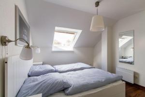a bedroom with a bed with blue sheets and a window at Ferienwohnung-Mour in Dahme