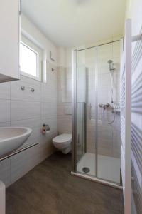 a bathroom with a shower and a toilet and a sink at Ferienwohnung-Mour in Dahme +10 photos
