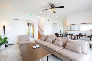 a living room with a couch and a table at Ocean Terrace金武 in Kin