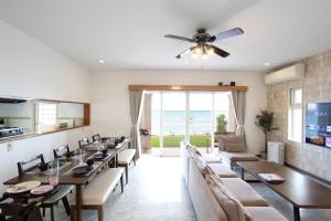 a dining room with long tables and chairs at Ocean Terrace金武 in Kin