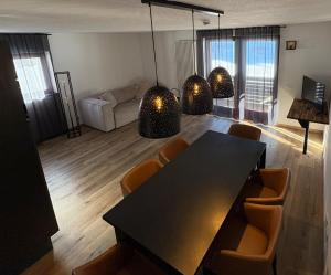 a living room with a dining table and chairs at Grifone Dolomiti Residences in Arabba