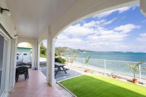 a balcony with a view of the water at Ocean Terrace金武 in Kin