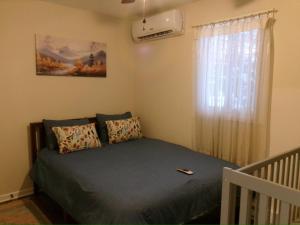 a bedroom with a bed and a window at Evergreen Escapes 4 BR with Game Room, Firepit near Kalahari and Camelback in Long Pond +47 photos