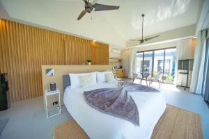 a bedroom with a large white bed in a room at Luxury villa with Private beach access in Sosúa