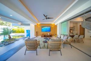 a large living room with a couch and chairs at Luxury villa with Private beach access in Sosúa