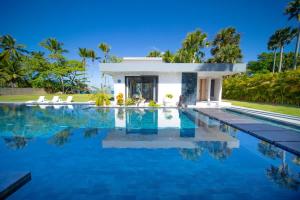 a swimming pool in front of a villa at Luxury villa with Private beach access in Sosúa