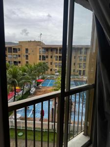 a view from a window of the pool and resort at Loft reserva do Sahy- condado in Mangaratiba